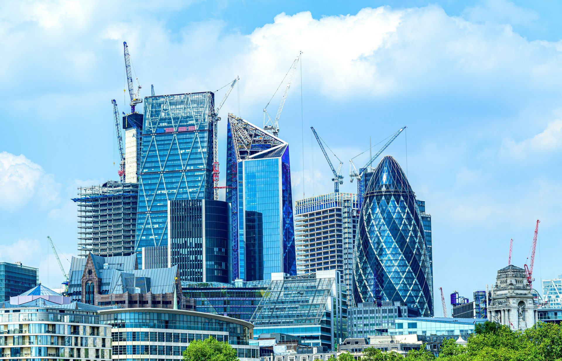 Modern skyscrapers under construction against blue sky